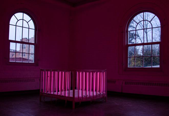  Pink neon crib-like sculpture.