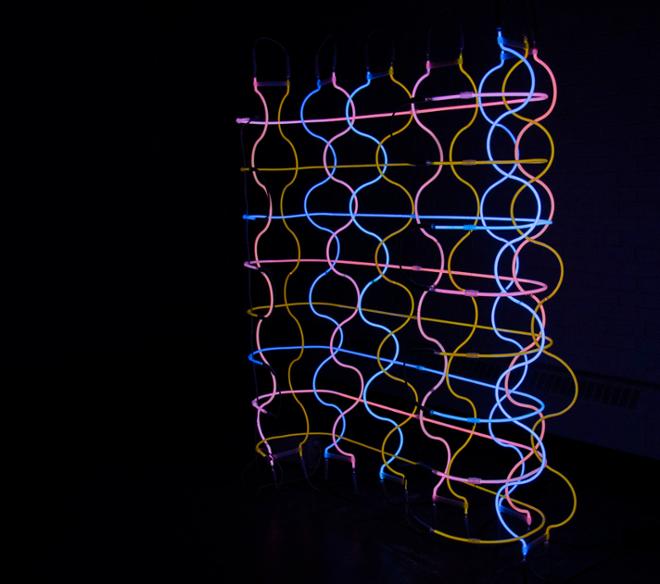 Multicolored neon tubes arranged in a weave-like manner. 
