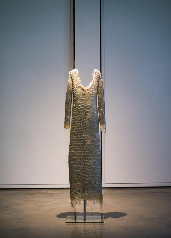 Dress standing alone without a person wearing it.  