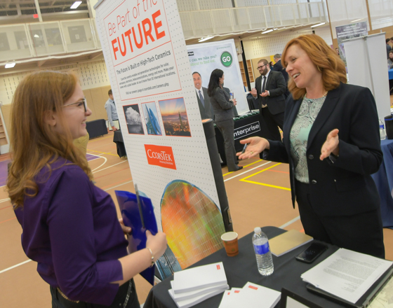 Students at the engineering career fair talking with prospective employers