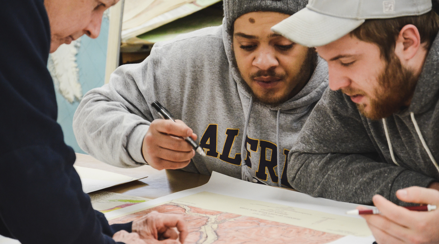 Students studying a geology map