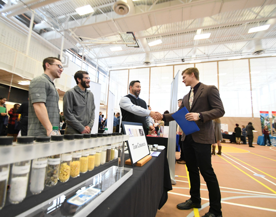 student meeting a group of employers at a job fair