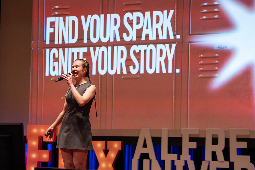 A photo of Alina Zabihailo onstage during TEDxAlfred University