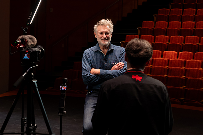 A photo of Bill Pullman being interviewed by an Alfred University student