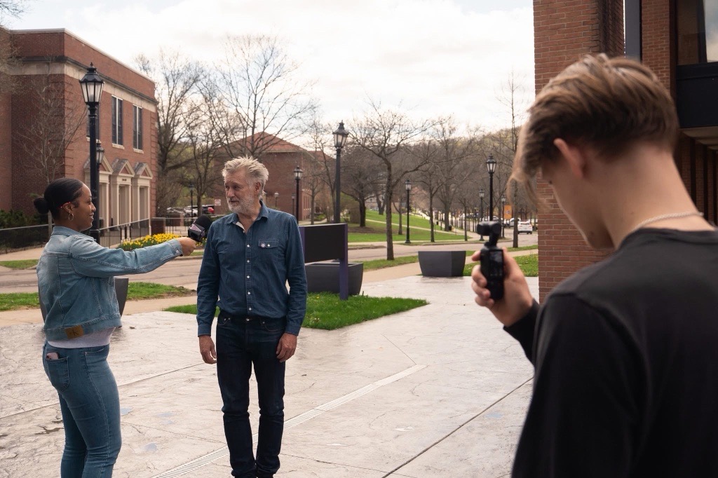 A photo of Bill Pullman being interviewed by Alfred University students