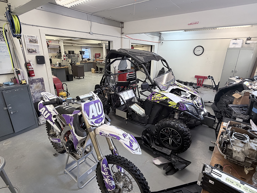 A photo of a dirt bike and a snowmobile