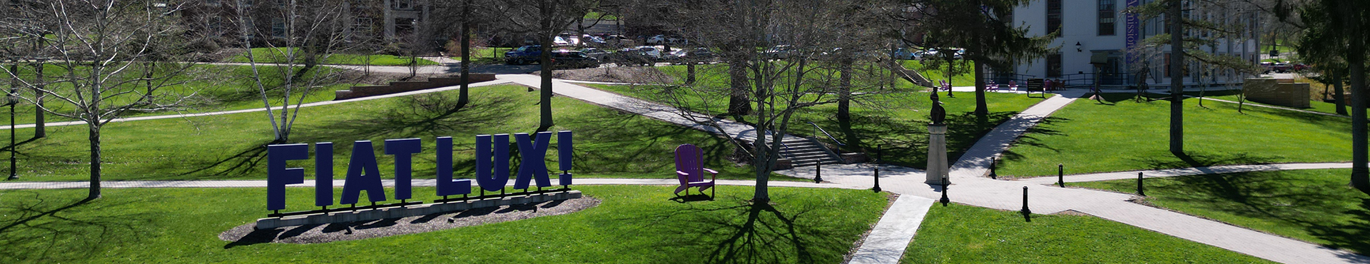 A drone shot of the Fiat Lux sign on Alfred University campus