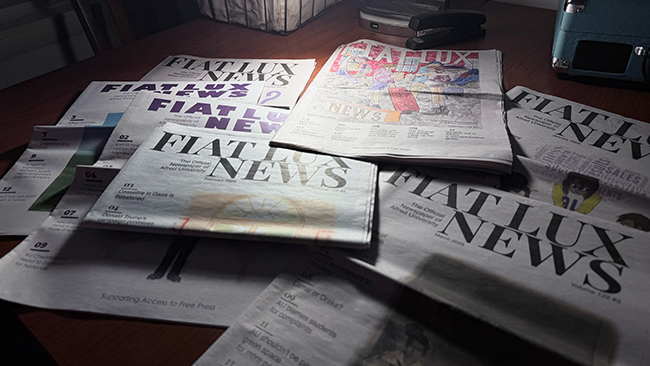 A photo of Fiat Lux newspapers spread out on a desk