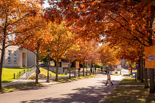 Fall photo of student near the Inamori School of Engineering