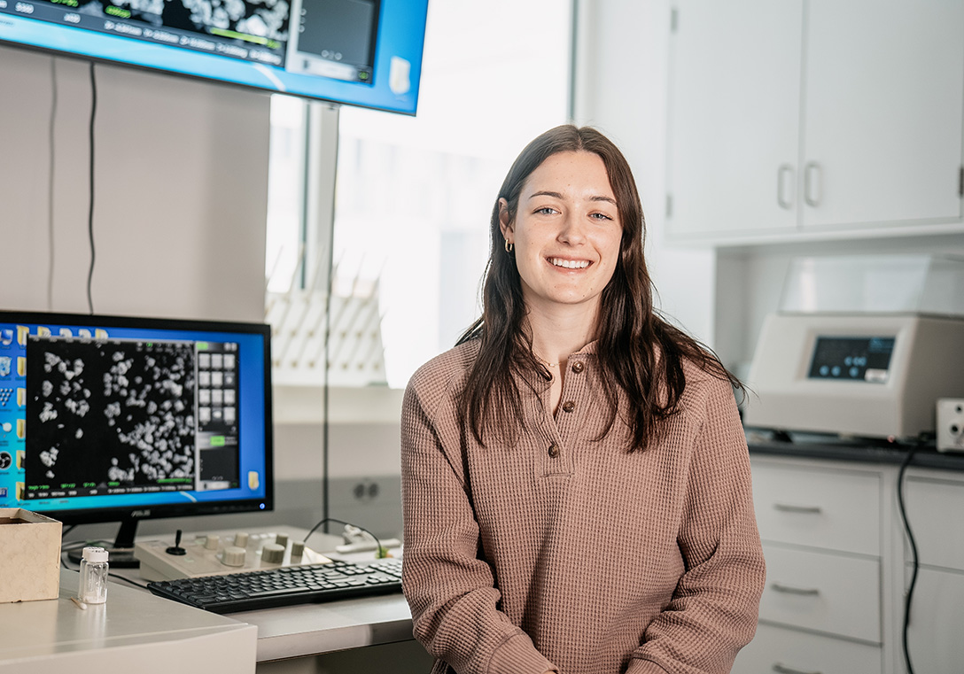 A photo of Lina Young sitting in an engineering lab
