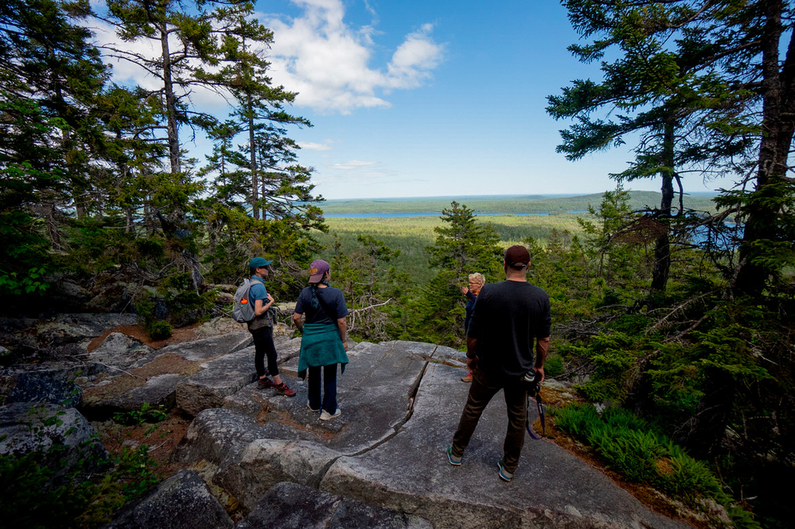 A photo of a people hiking along the coast of Maine