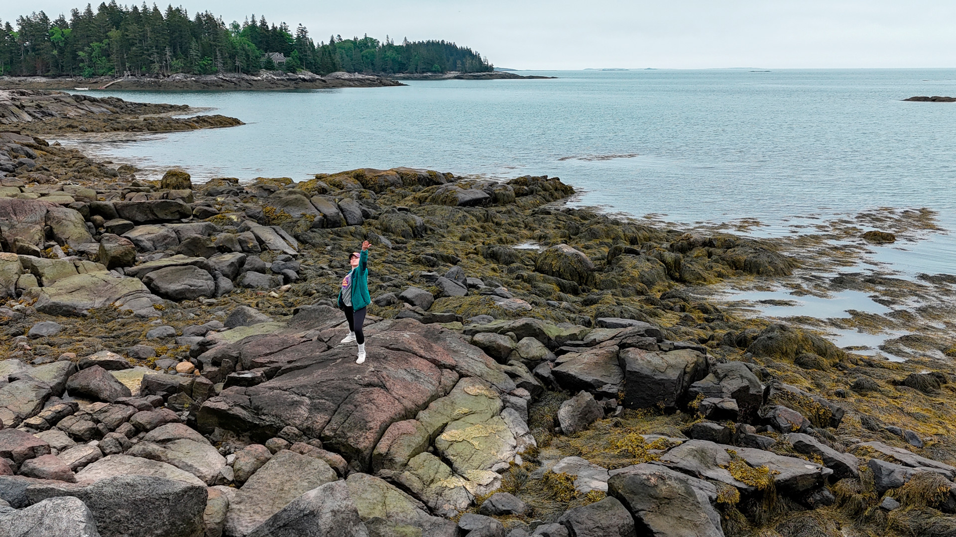 A photo of a woman standing on the coast of Maine