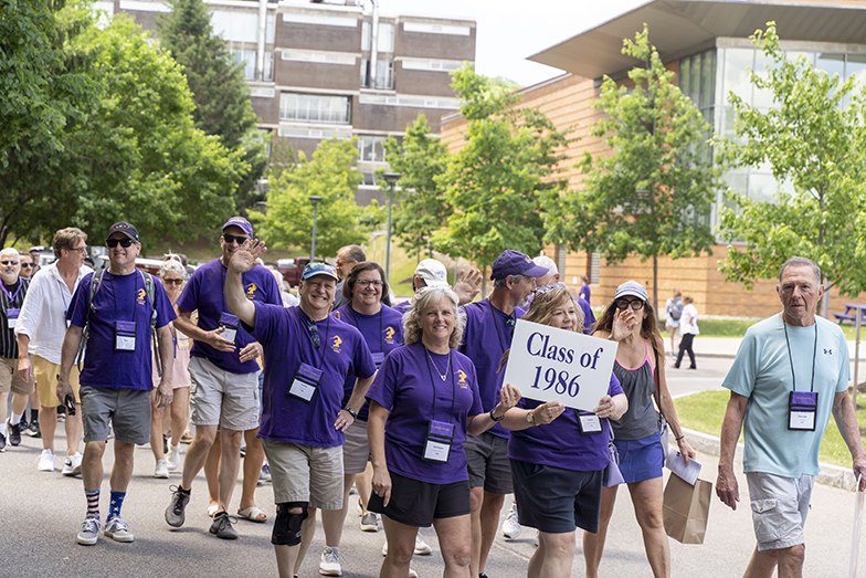 A photo of Alfred University alumni walking in a procession around campus