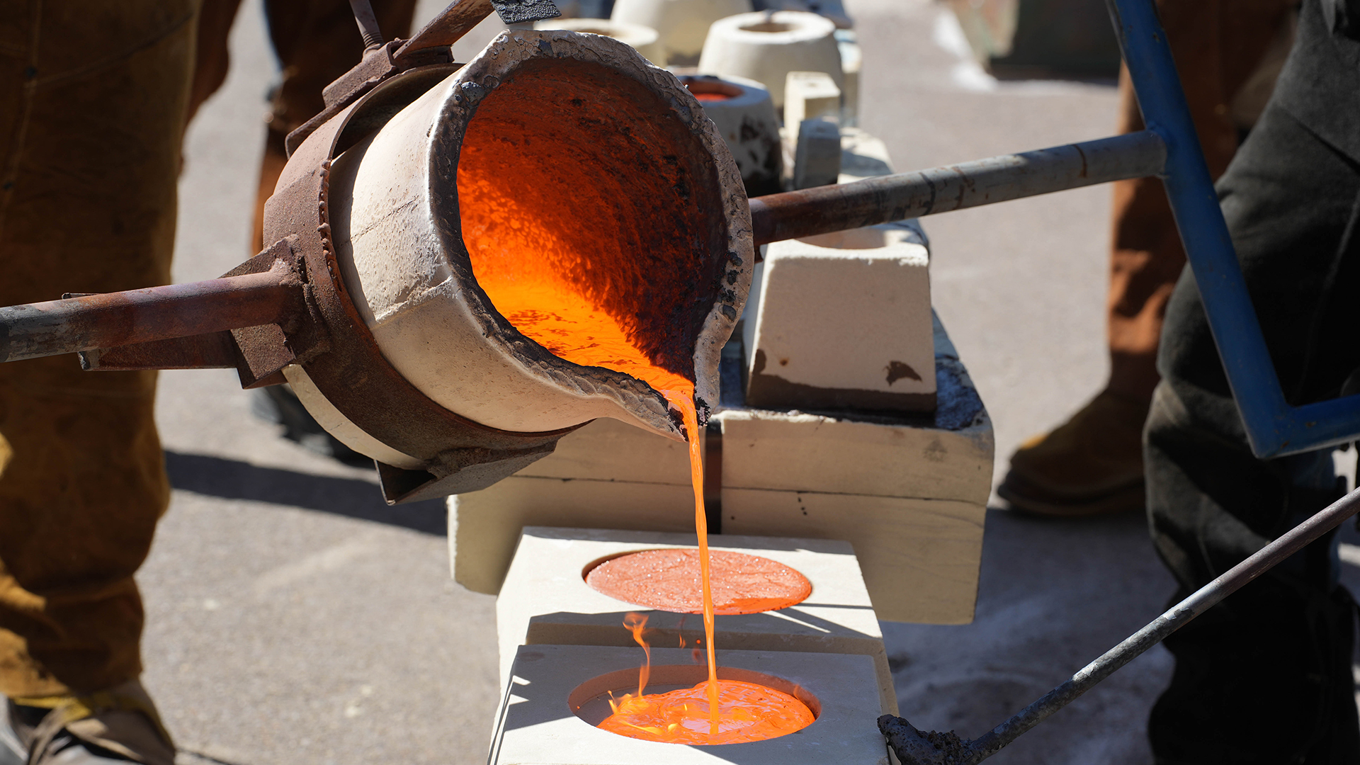 A photo of molten lava being poured into a large stone mold