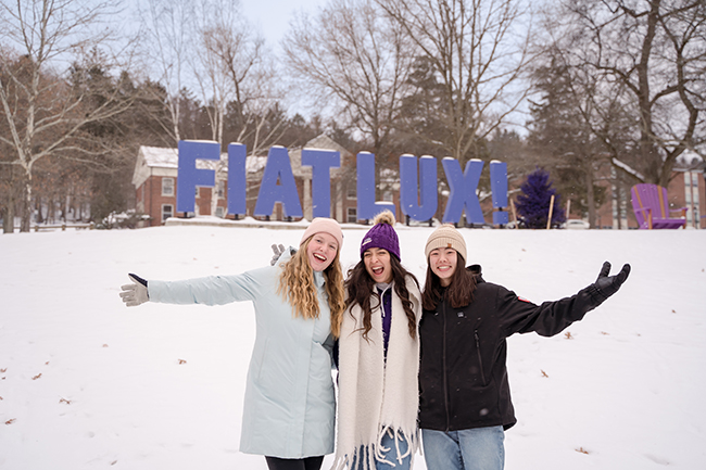 A photo of students smiling in the snow