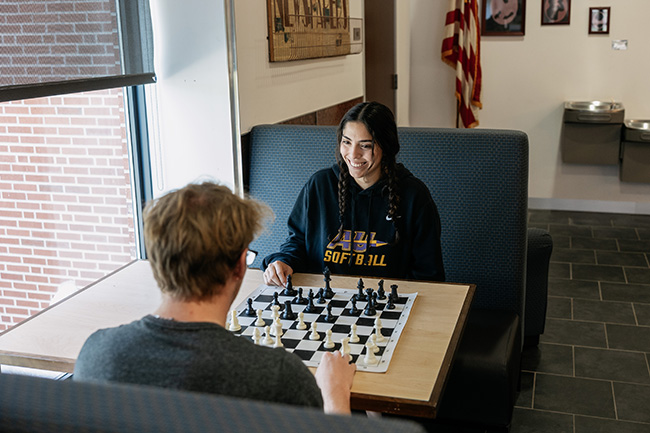 A photo of two Alfred University students playing chess