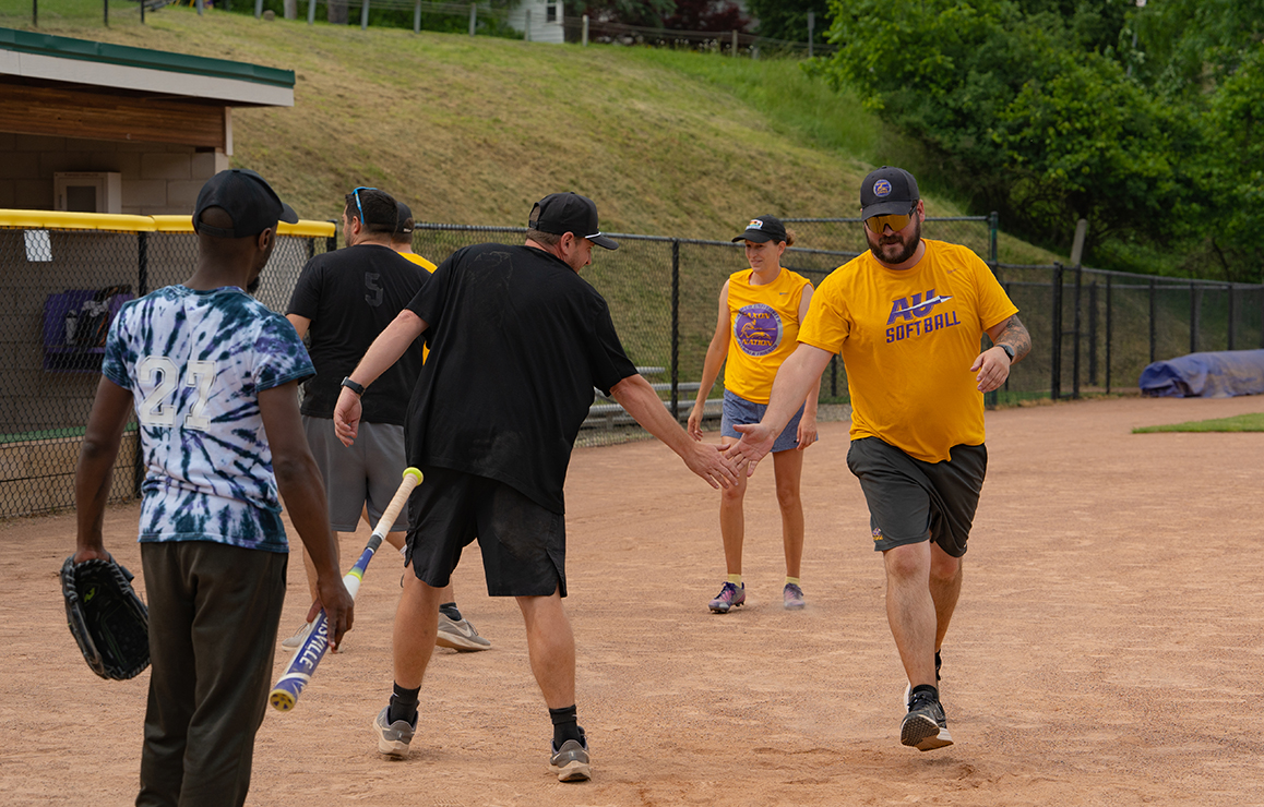 A photo of Alfred University faculty and staff playing softball
