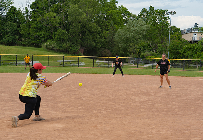 A photo of Alfred University faculty and staff playing softball