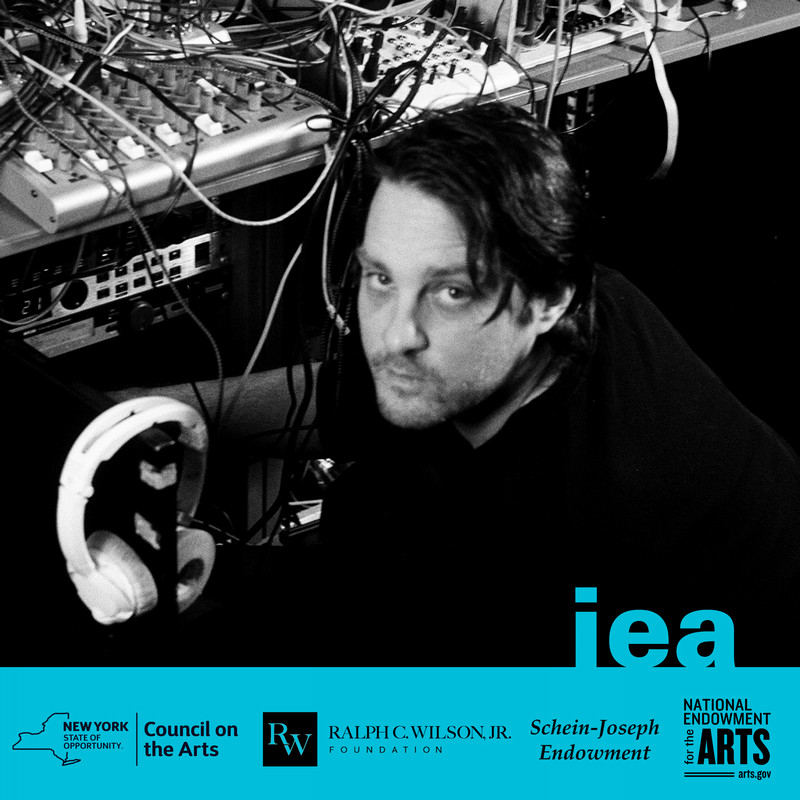 Black and white photo of artist working with sound equipment