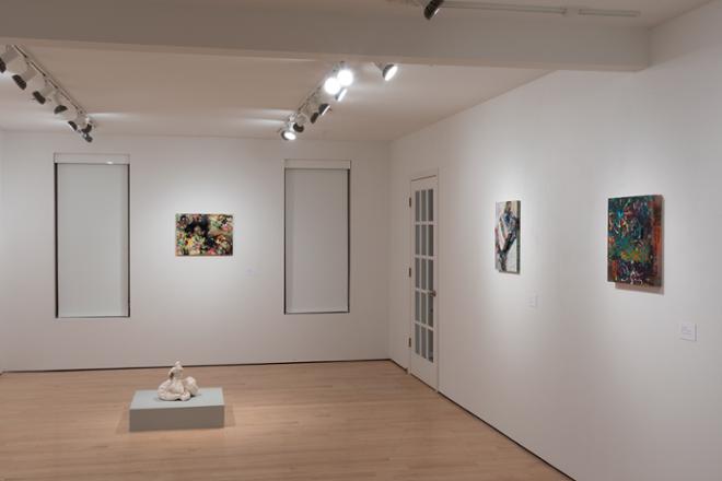 another corner of gallery space featuring various sculptures and paintings