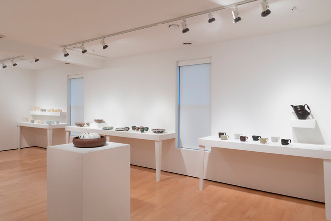 side view of gallery space with pottery displayed