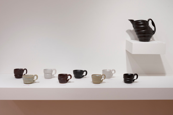 black vase and various colored mugs