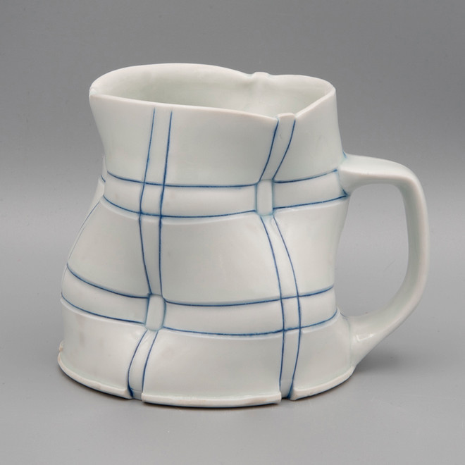 white mug with blue checkered stripes