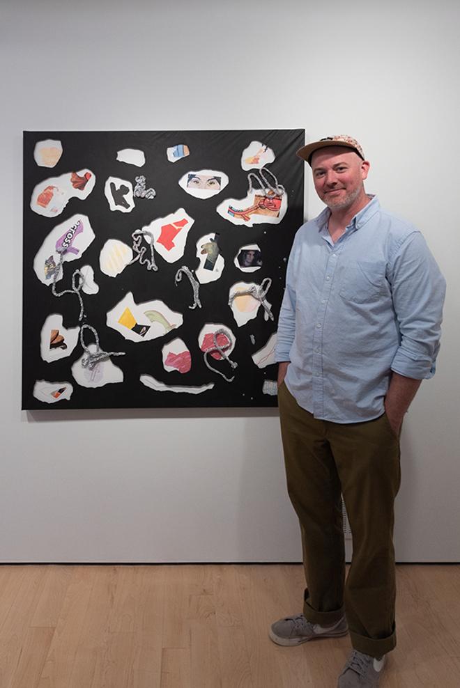 Trevor the artist, posing with artwork