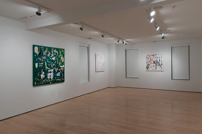 corner of gallery with artwork and paintings hung on the wall