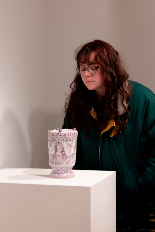 person looking at a vase