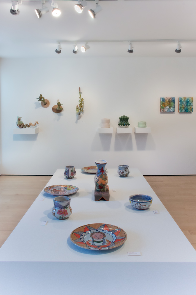 gallery space filled with plates, vases and other items for sale