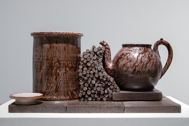 close up look at ceramic tray and brown wood grain styled ceramic jar and teapot