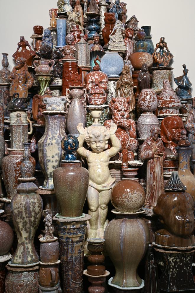 closer look at group of various sized ceramic figures and vases together