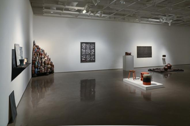 gallery space filled with sculptures on display