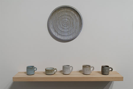 ceramic cup sets with a large plate hung