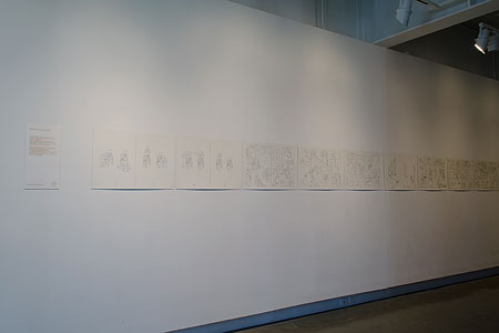 row of comic strip prints on a wall