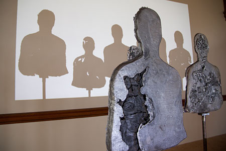 sculpture of figures projecting shadows