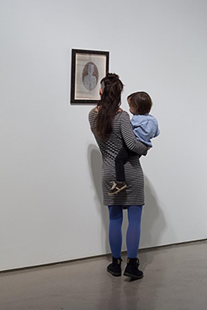 A Parent Holding a Child to See Art