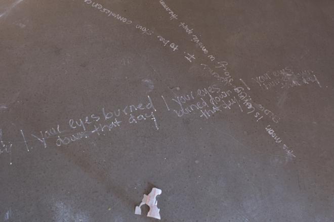 Chalk written words on the floor and a piece of cloth