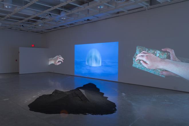 Erin Ethridge hands with ocean projecting on the wall