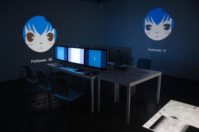dark room of computers and projections on the wall