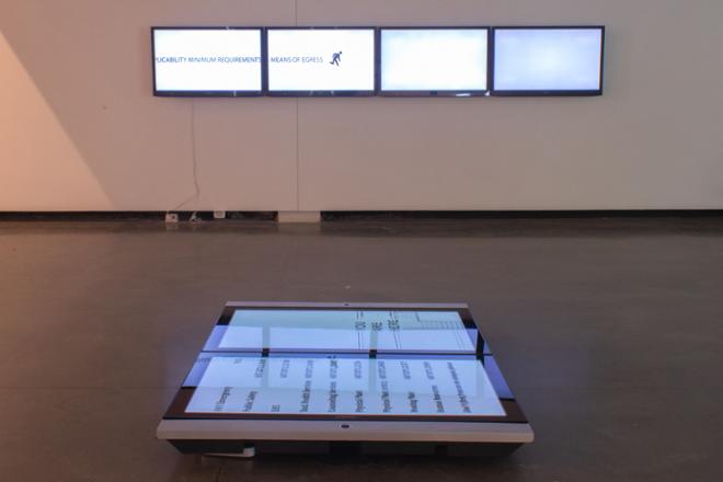 floor piece and series of screens on wall