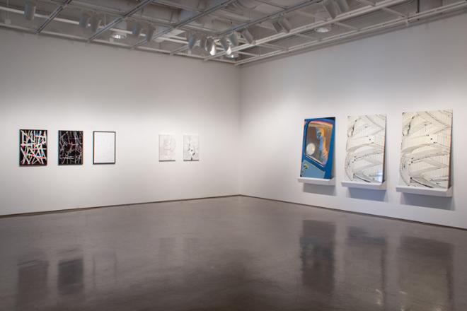 installation view of a group of small paintings and another group of large paintings
