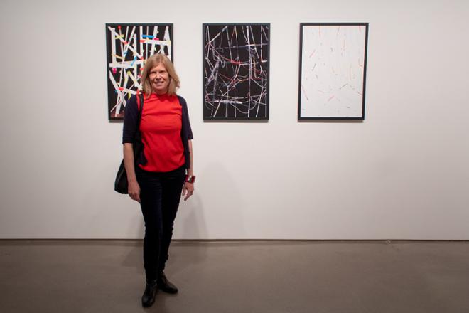 Artist Ellen Bahr posing in front of her work