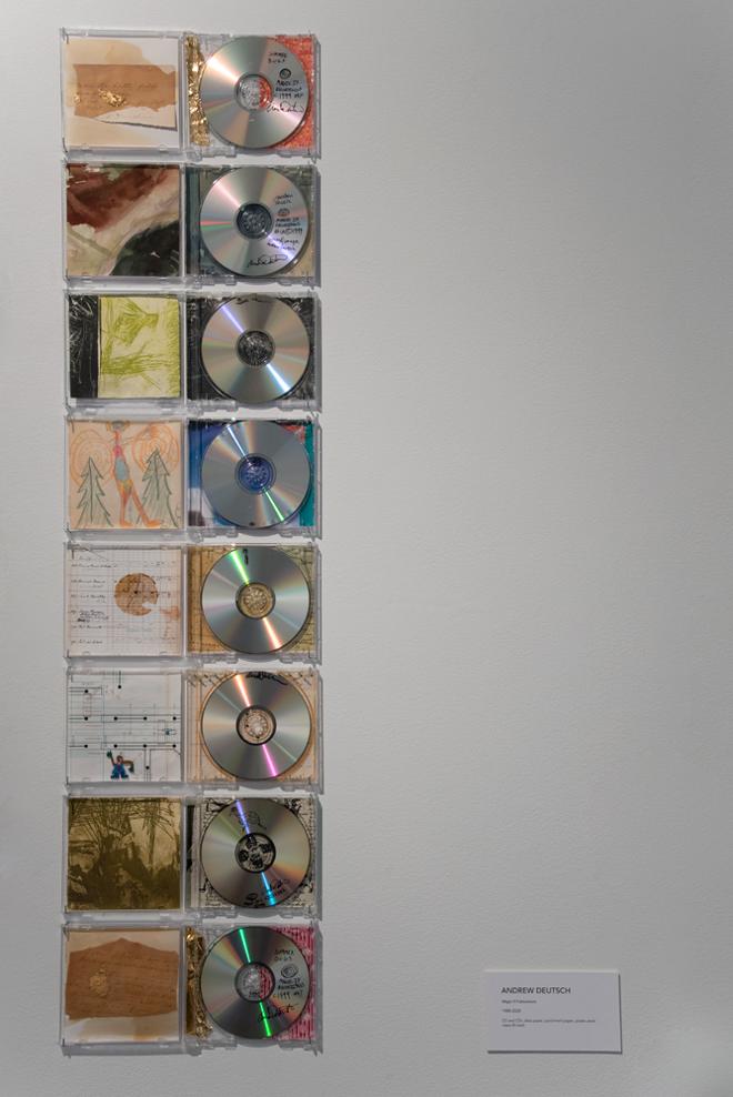 cds with cover art hung on wall