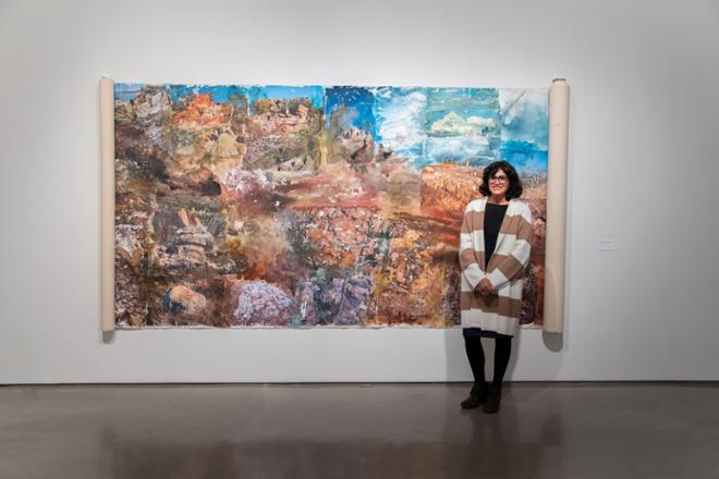 Maria posing next to large art piece 