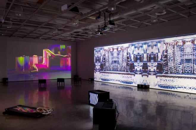 walls filled with artwork and projections of video