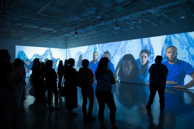 group of people watching video in immersive gallery