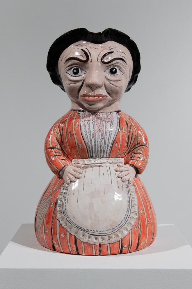 ceramic lady with black hair, a dress, with an apron