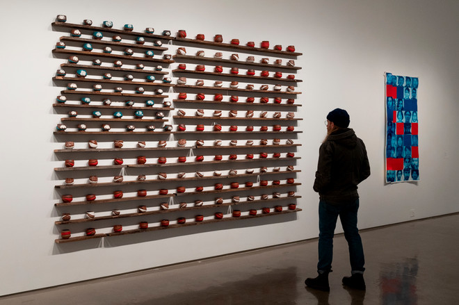 art piece that depicts the flag of the United States using ceramic cups painted red, white, and blue by Ashlyn Pope